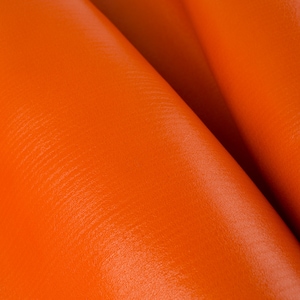 May include: Close-up of vibrant orange leather material, showing the texture and folds of the fabric. The leather has a smooth, glossy finish, and the color is consistent throughout the image.