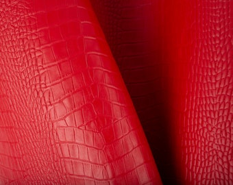 May include: Red faux leather with a crocodile embossed pattern.