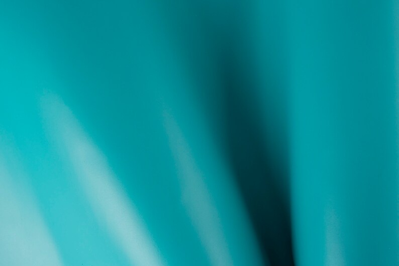 May include: A smooth, solid teal blue background with a subtle gradient effect.