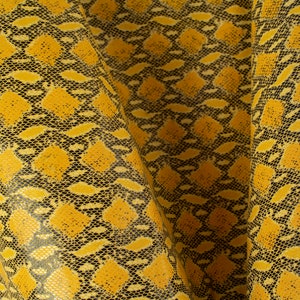 May include: Yellow and black snakeskin fabric with a textured pattern.