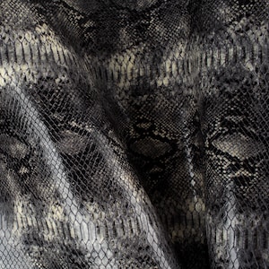 May include: Black and white snakeskin fabric with a textured pattern.