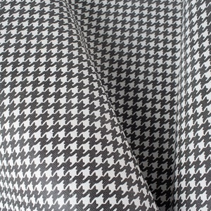 May include: Black and white houndstooth fabric with a textured surface.