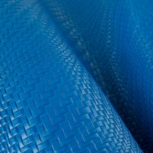 May include: Close-up of a blue woven leather fabric with a textured surface.