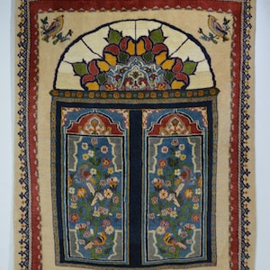 May include: A beige rug with a colorful stained glass window design in the center. The window is framed by a dark blue border and features intricate floral patterns. Two birds are perched on branches on either side of the window.