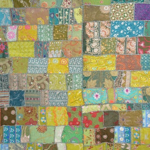 May include: A patchwork quilt featuring a range of colours and patterns, including green, blue, yellow, and red. The quilt is made from various fabrics, some of which are embroidered. This quilt is a unique and handcrafted piece of art.