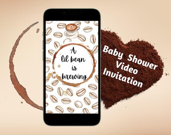 May include: A smartphone screen displays a coffee-themed baby shower video invitation with the text "A lil bean is brewing" inside a coffee ring. The background is a pattern of coffee beans. The phone is on a light brown surface with a heart-shaped pile of coffee grounds that says "Baby Shower Video Invitation".