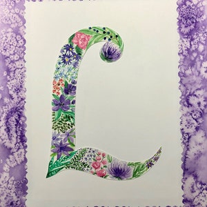 May include: A watercolor painting of the letter L, decorated with purple, pink, and green flowers. The letter is surrounded by a purple border.