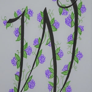 May include: A black calligraphy letter W with a vine of purple flowers and green leaves.