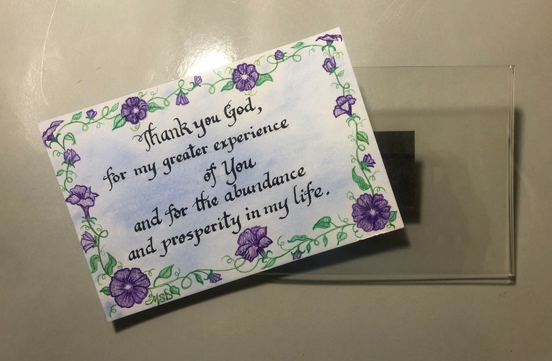 May include: A handwritten note with a floral border and the text "Thank you God, for my greater experience of You and for the abundance and prosperity in my life."