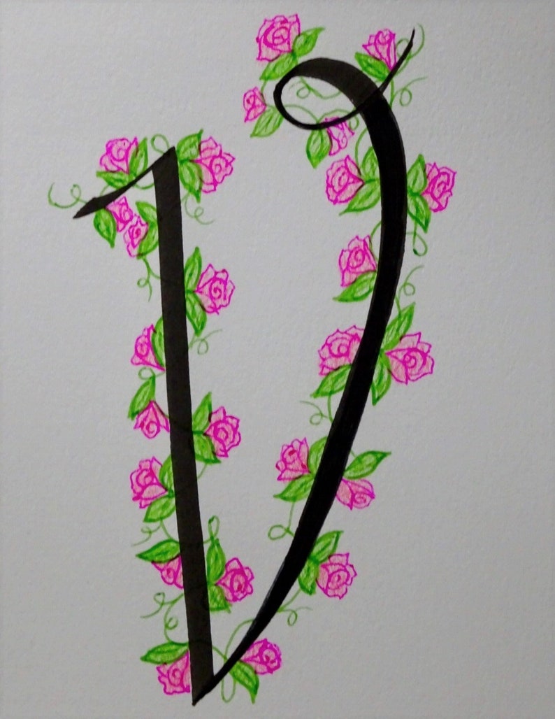 May include: A black calligraphic letter V with a vine of pink roses and green leaves wrapping around it.