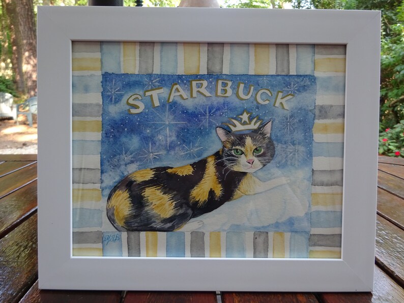 May include: A watercolor painting of a calico cat wearing a gold crown. The cat is sitting on a cloud with a blue starry background. The word "STARBUCK" is written in gold letters at the top of the painting.