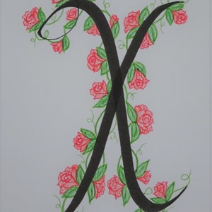 May include: A black calligraphic letter X with a vine of red roses and green leaves winding around it.