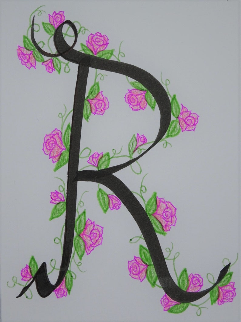 May include: A black calligraphic letter R with pink roses and green leaves drawn around it.