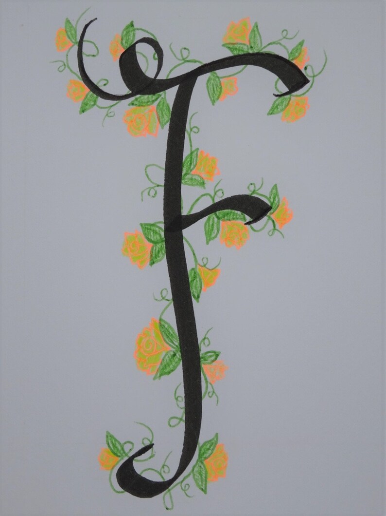 May include: A black calligraphic letter F with a vine of green leaves and orange flowers winding around it.