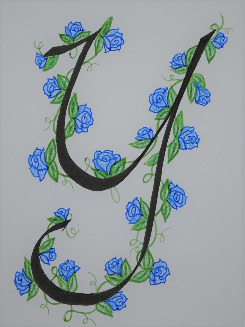 May include: A black calligraphic letter 'J' with blue roses and green leaves winding around it.