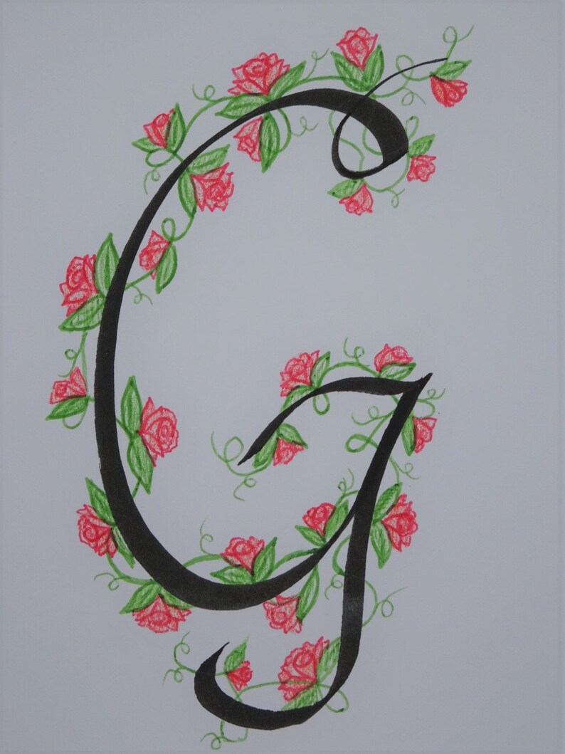 May include: A black calligraphic letter G with a vine of red roses and green leaves winding around it.