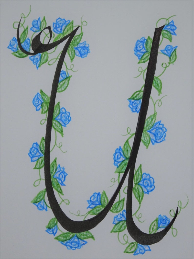 May include: A black calligraphic letter U with a vine of blue flowers and green leaves wrapping around it.