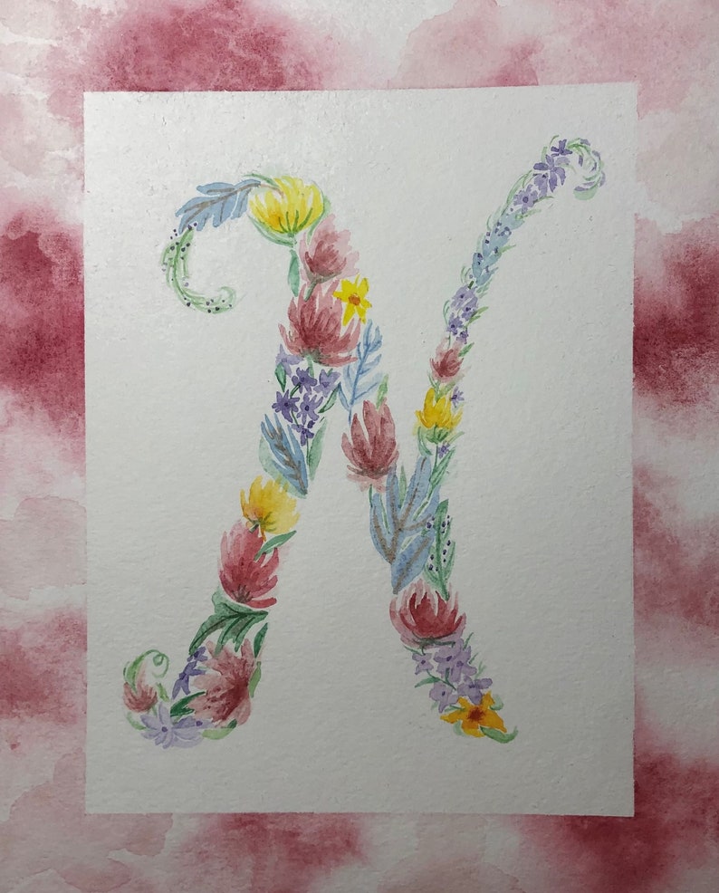 May include: Watercolor painting of the letter N made up of flowers in shades of pink, purple, yellow, and blue.