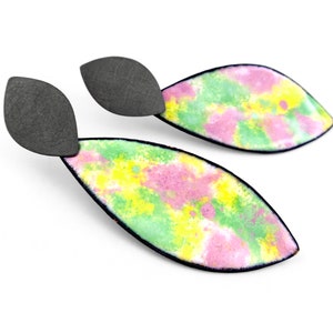 May include: A pair of dangle earrings with a black metal top and a colorful enamel bottom. The enamel is a mix of green, yellow, and pink.