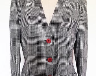 May include: A black and white plaid blazer with a v-neck and three red buttons.