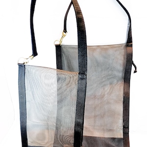 May include: Two black mesh bags with black straps and a drawstring closure. The bags are made of a fine mesh material and have a black fabric trim around the edges.