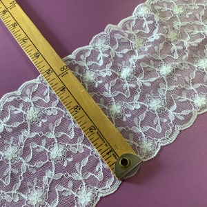 5.5” wide white lace ,delicate pattern of flowers and leaves ,sold by the metre