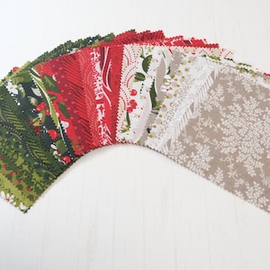 May include: A selection of fabric squares in green, red, white, and beige. The fabric pieces display floral and patterned designs, suitable for quilting or craft projects. The squares are arranged in a semi-circle.