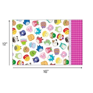 May include: A rectangular pillowcase, 40.6 cm wide by 30.5 cm high, with a pattern of colourful cartoon characters on a white background. The right side has a pink plaid design.