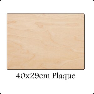 May include: A natural wood plaque measuring 40 by 29 centimetres. The plaque is light brown with a wood grain pattern.