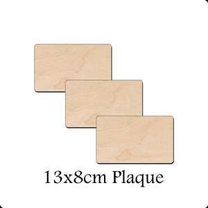 May include: Three rectangular wooden plaques with rounded corners, arranged diagonally. The plaques are light tan with visible wood grain. Each plaque measures 13x8cm. The text "13x8cm Plaque" is displayed below the plaques.