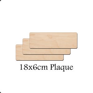 May include: Three unfinished wooden plaques, each measuring 18cm by 6cm. The plaques are stacked on top of each other, with the top plaque being the largest. The plaques are made of light-colored wood and have a smooth surface. 18x6cm Plaque