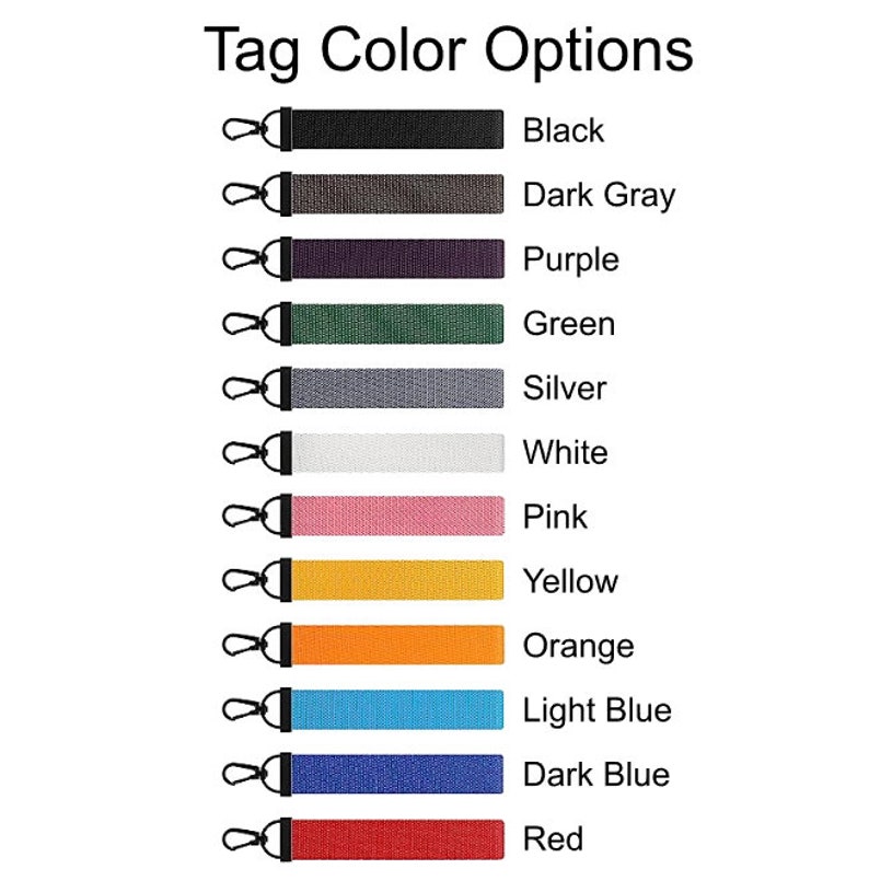 May include: Image showing a variety of tag color options. Each tag is a different color, including black, dark gray, purple, green, silver, white, pink, yellow, orange, light blue, dark blue, and red. Each tag has a black metal clasp.