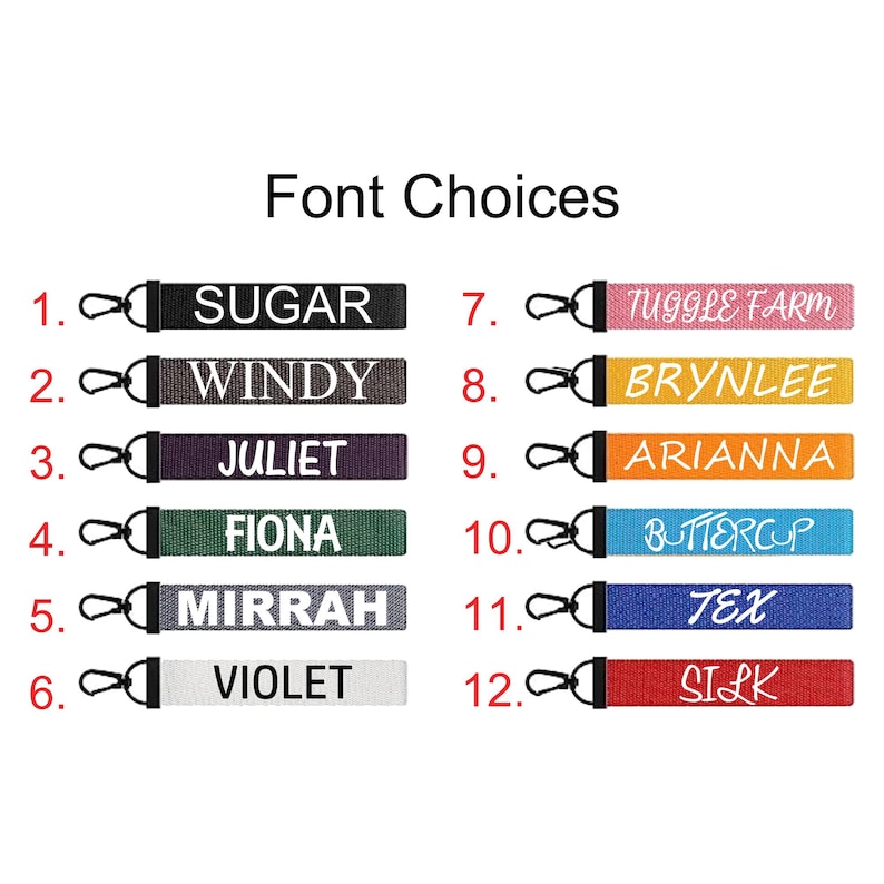 May include: A selection of twelve personalized lanyard keychains in various colors, each with a different name or word printed in white. The keychains have a black clasp and are displayed against a white background.