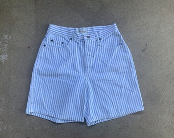May include: Blue and white striped denim shorts with a button and zipper closure. The shorts have a classic fit and are made of a lightweight fabric.
