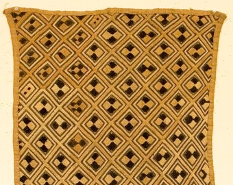 May include: A square textile with a repeating diamond pattern. The diamonds are tan with black and white checkered squares at the center. The border is a darker tan. The dimensions are 19 x 19 inches.
