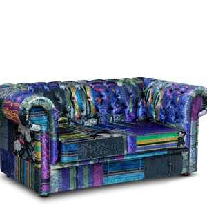 May include: A two-seater sofa with a patchwork design. The sofa features a variety of fabrics in shades of blue, purple, green, and black. The rolled arms and button-tufted back add a classic touch to this unique piece of furniture.
