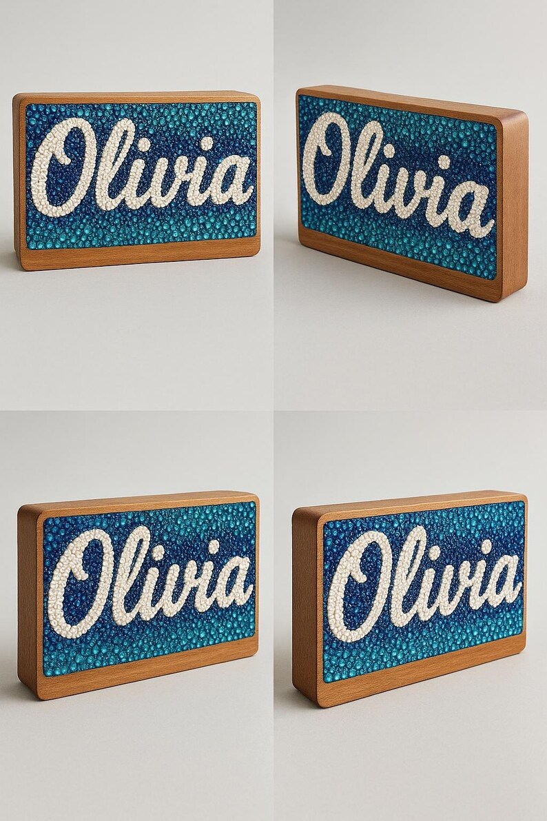 May include: Wooden nameplate with the name "Olivia" in white script. The name is set against a textured blue background, framed by a light brown wooden border. The nameplate is rectangular and appears to be a decorative item.