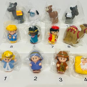 May include: A collection of plastic nativity scene figurines, including a camel, donkey, sheep, and various human figures. Each figure is individually packaged in clear plastic.