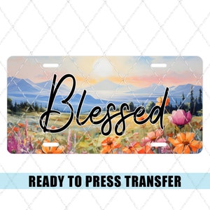 May include: A ready to press transfer with a sunset landscape and wildflowers. The text "Blessed" is written in a cursive font.