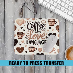 May include: A brown and white mouse pad with a coffee cup and heart design. The text "Coffee is my Love Language" is printed on the mouse pad.