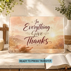 May include: A rectangular sublimation transfer sheet featuring a sunset landscape with mountains and a pair of open hands. The text "In Everything Give Thanks" is printed in a dark red script font across the center of the image.