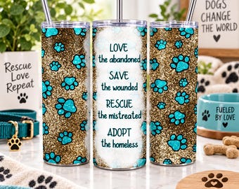 May include: A cylindrical stainless steel tumbler with a straw, featuring a gold glitter background covered in teal paw prints. The center text reads: LOVE the abandoned, SAVE the wounded, RESCUE the mistreated, ADOPT the homeless.