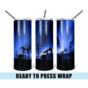 May include: Three stainless steel tumblers with a blue and black design featuring a silhouette of oil rigs against a starry night sky. The tumblers are ready to be pressed with a design.