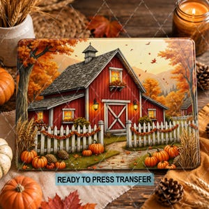 May include: A rectangular heat transfer print featuring a red barn with a gray roof, white picket fence, and pumpkins. The scene includes autumn trees, falling leaves, and a stone path. The text READY TO PRESS TRANSFER is printed in blue.