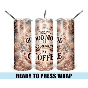 May include: A stainless steel tumbler with a straw, featuring a floral and coffee-themed design. The text reads "Today's Good Mood Is Sponsored By Coffee." The design includes coffee beans and decorative elements in shades of brown, beige, and white.