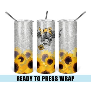 May include: A sublimation design for a tumbler featuring a Highland cow with a yellow bow, surrounded by sunflowers on a silver glitter background. The design is ready to be pressed onto a tumbler.