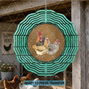 May include: A circular metal wind spinner featuring a teal scalloped border and a central design of three chickens against a tan chicken wire background. The spinner is suspended by a silver chain and displays a detailed illustration of poultry.
