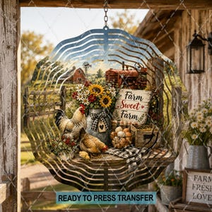 May include: A circular metal wind spinner featuring a printed farm scene with a rooster, a hen, a red tractor, a bouquet of sunflowers, and a wooden sign that reads Farm Sweet Farm. The design includes a small crate of eggs and a plaid ribbon.