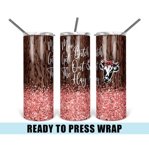 May include: A stainless steel tumbler with a wood grain design and pink glitter at the bottom. The tumbler has a straw and says "Moo Bitch Get Out The Hay" with a cow wearing a red bandana.