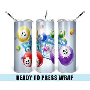 May include: Three sublimation tumblers with a blue background and colorful bingo balls. The tumblers feature a bingo card with the word "BINGO" and numbers. The tumblers are ready to be pressed with a design.